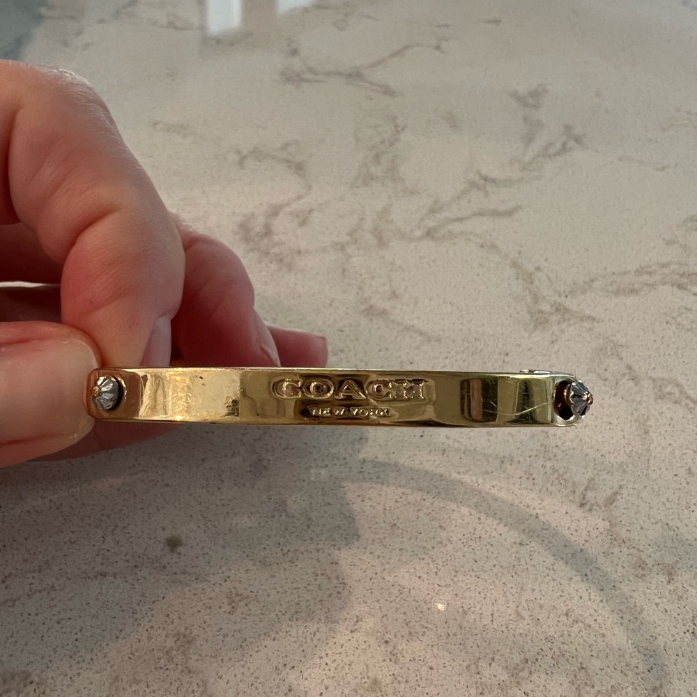 Coach bangle bracelet. Gold filled. Fits 7” wrist. Normal wear, minor scratches